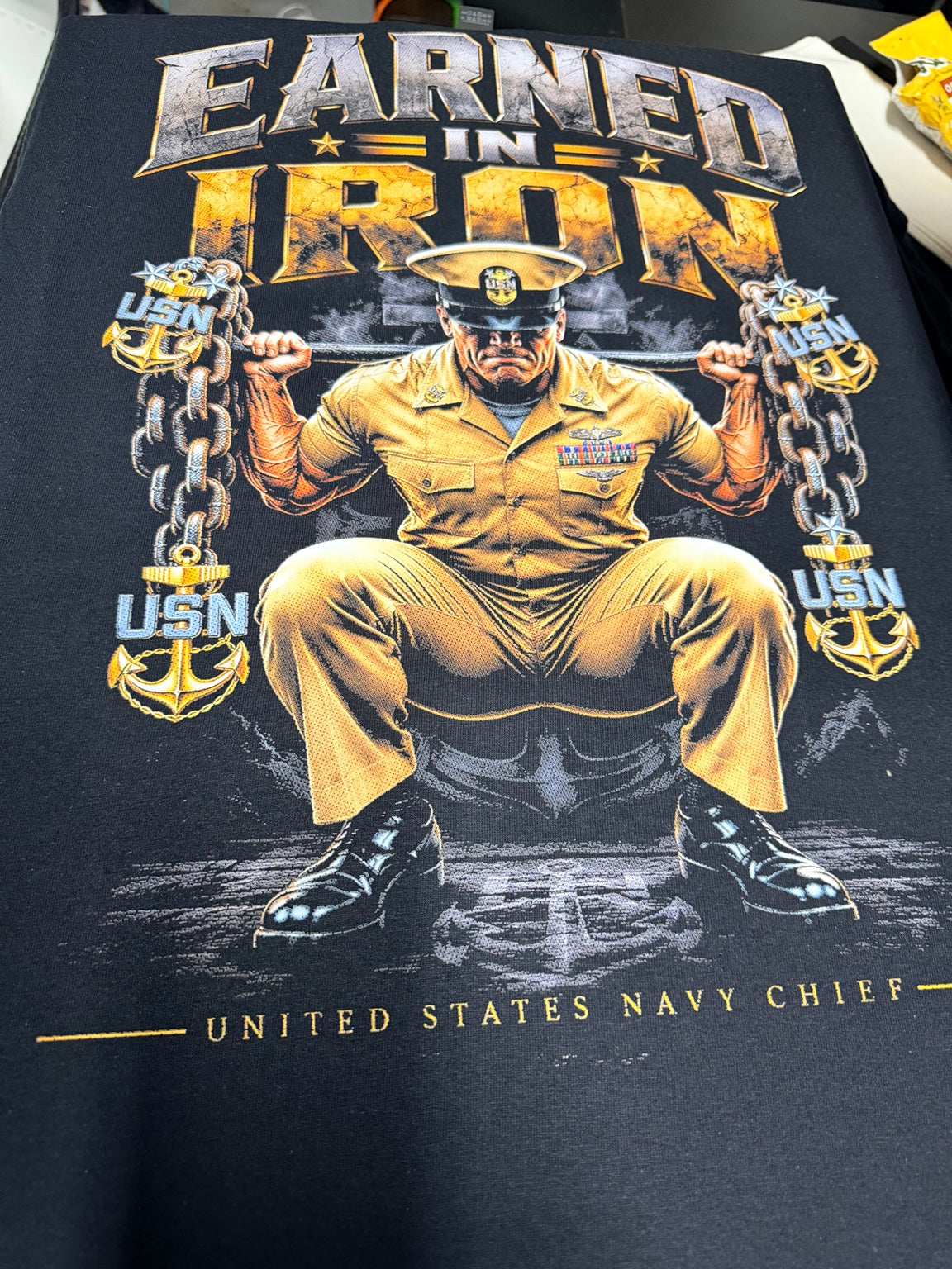 Earned in Iron Navy Chief back print on black T-shirt