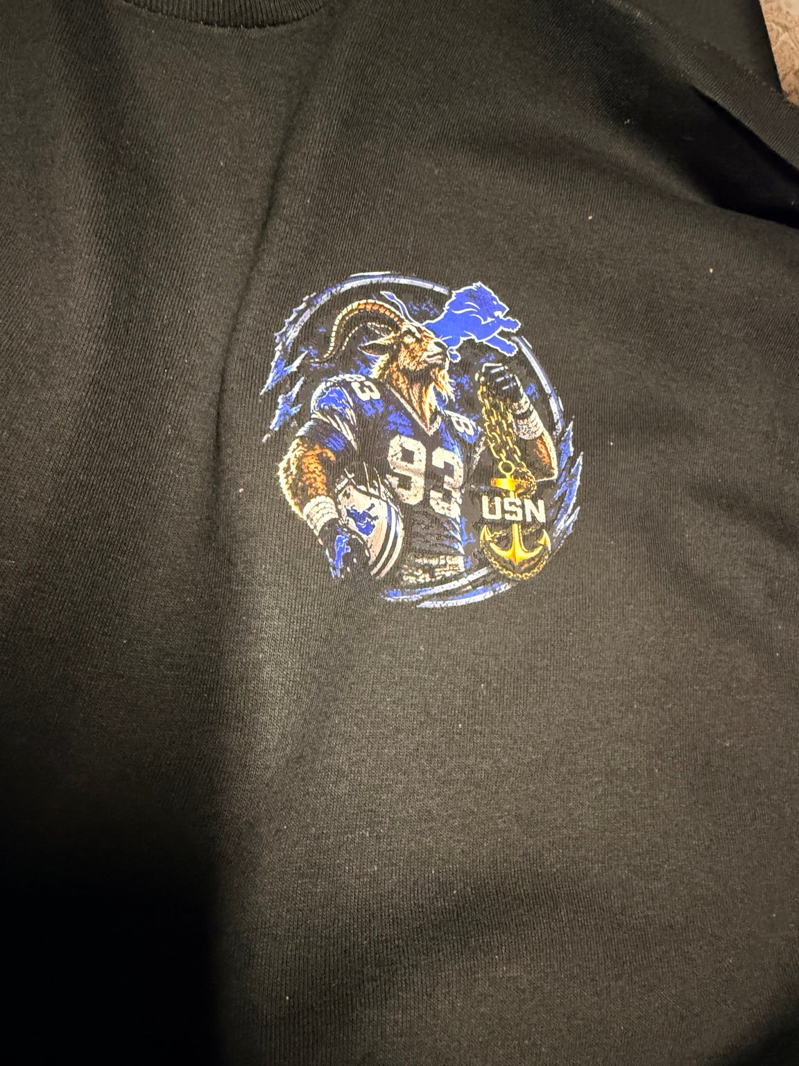 Lions Den circular goat and anchor left chest print on black shirt